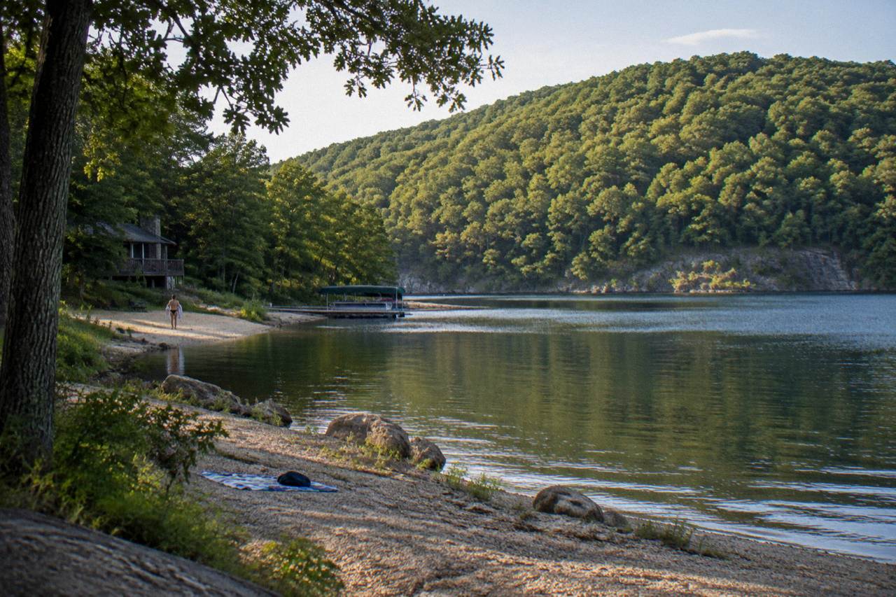 A quiet cove on Deep Creek Lake with tree-covered hills rising above the water