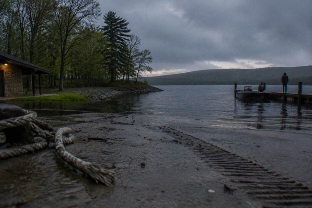A public boat ramp on a lake with a forested point stretching into the distance