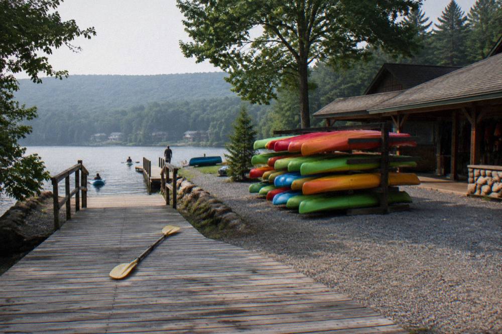 A marina dock with rental boats moored in rows along a quiet lake cove