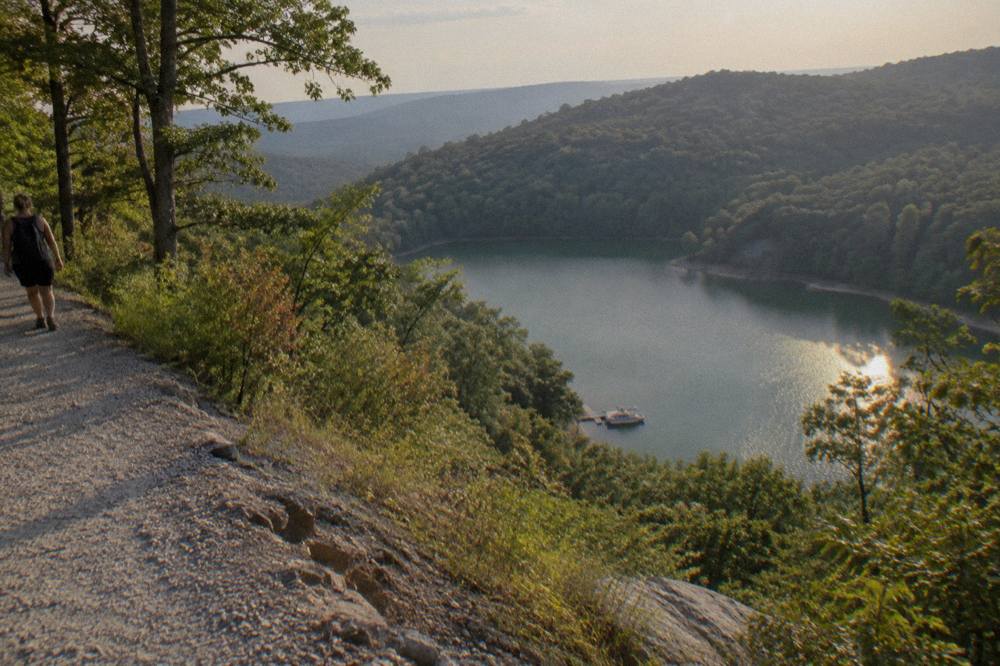 A quiet cove on Deep Creek Lake with tree-covered hills in the background