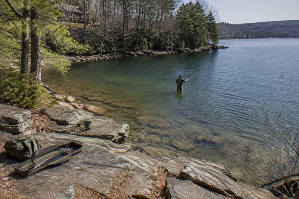 Rocky point extending into a quiet lake cove with clear water