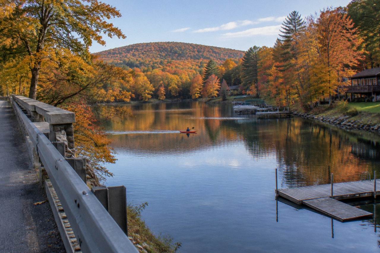 Quiet cove on Deep Creek Lake with forested shoreline in fall color