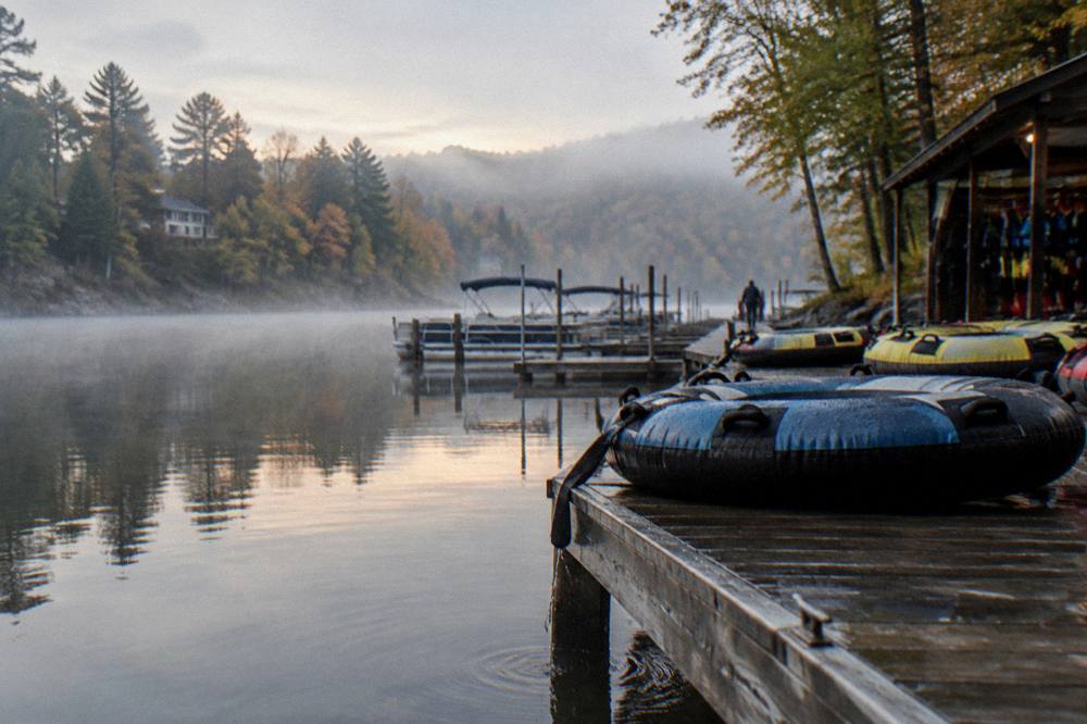 Sunrise light on a mirror-calm lake cove with mist over the water